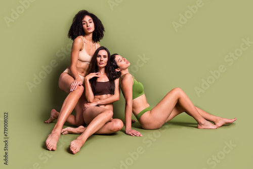 Full length studio photo of shiny seductive women wear lingerie no filter skin hugging empty space isolated pastel khaki color background
