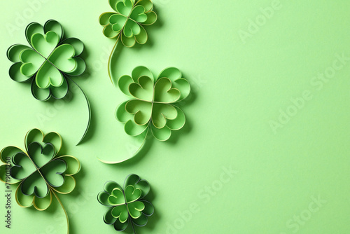 Paper art four leaf clover on green table. St Patricks Day background.