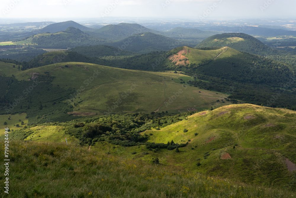 Auvergne vulcan since top of the Puy de Dome vulcan at sunset. Dramatic light landscape. Clermont Ferrand, France.