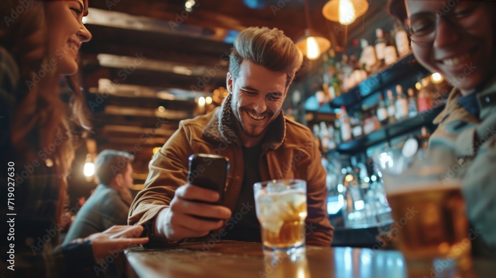 Close-up of a man using his cell phone while with friends in a bar.