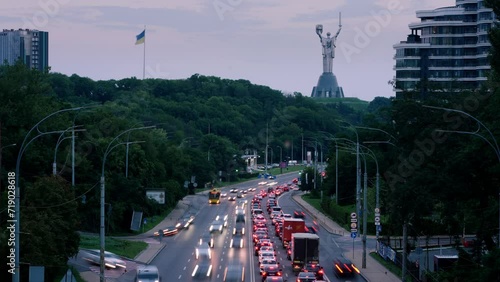 Kyiv city time laps with many cars and buses on speed during the sunset photo