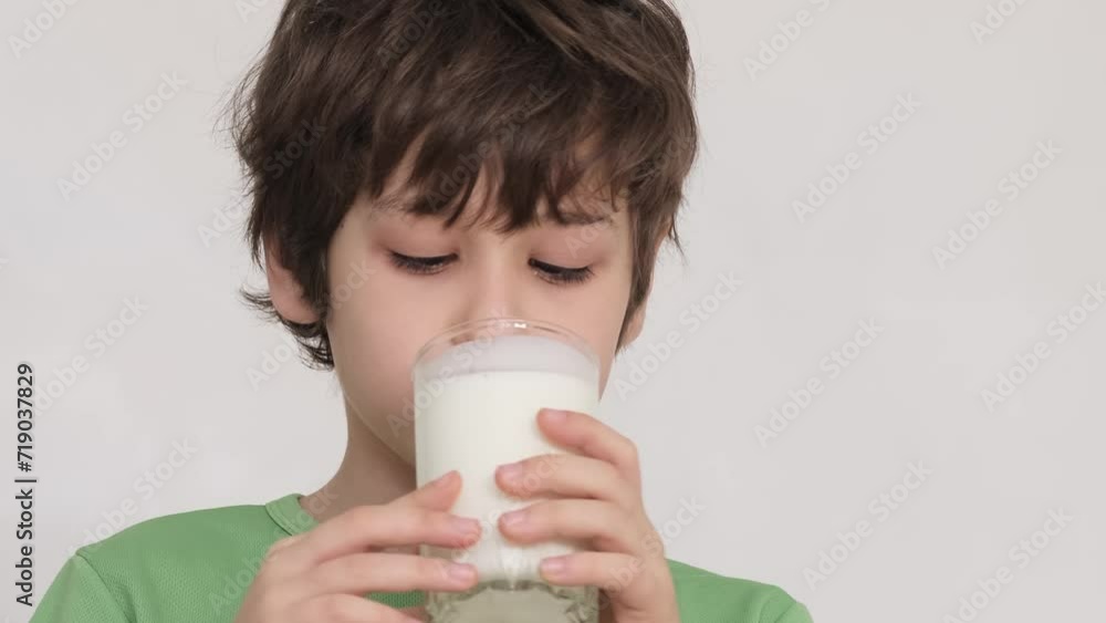 Young child savoring his yogurt, a playful mustache adorning his upper lip. Perfect for advertising healthy snack options for kids. Young child savoring his yogurt, a playful mustache adorning his upper lip. Perfect for advertising healthy snack options for kids.