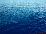 Beautiful rich blue texture of the sea with small waves