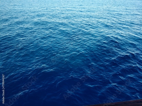 Beautiful rich blue texture of the sea with small waves