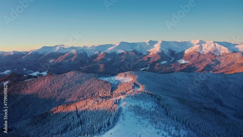 Epic Winter Aerial Landscape at pink Sunrise. Cinematic Snowy Winter. 