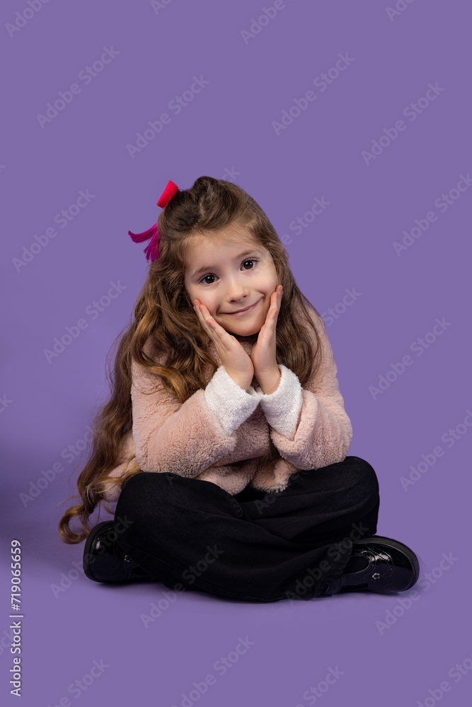 The picture of a surprised little girl sitting down and sitting very well, she has positive emotions and is very beautiful surprised. The picture of a surprised little girl sitting down and sitting very well, she has positive emotions and is very beautiful surprised.