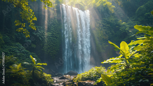 A majestic waterfall surrounded by dense greenery with bright sunlight