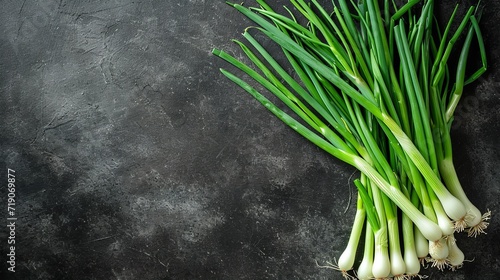 Top view of fresh green onion with a big copy space on black surface, Generative AI.