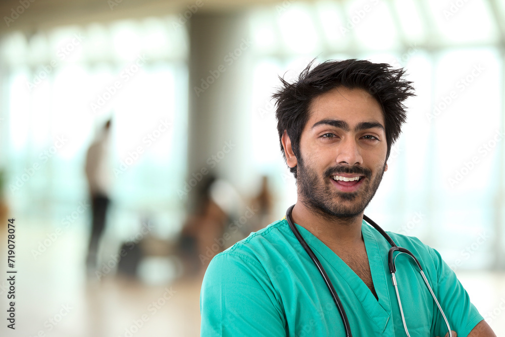 Male Indian healthcare worker wearing a green Scrubs with a stethoscope around his neck. Male Indian healthcare worker wearing a green Scrubs with a stethoscope around his neck.