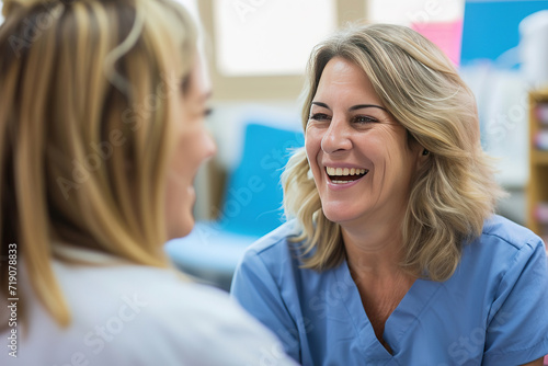 Senior patient, funny or happy caregiver talking for healthcare support at nursing home clinic. Smile, women laughing or nurse speaking of joke to a mature person or woman in a friendly conversation photo