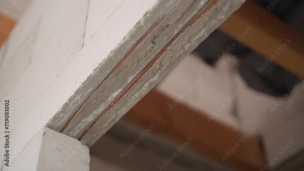 Close-up of a reinforced doorway in a wall made of a thin aerated concrete block. Building walls and planning a house. Metal rods for strengthening and solidity of the structure Close-up of a reinforced doorway in a wall made of a thin aerated concrete block. Building walls and planning a house. Metal rods for strengthening and solidity of the structure