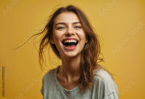 Ritratto di una ragazza sorridente su sfondo giallo photo