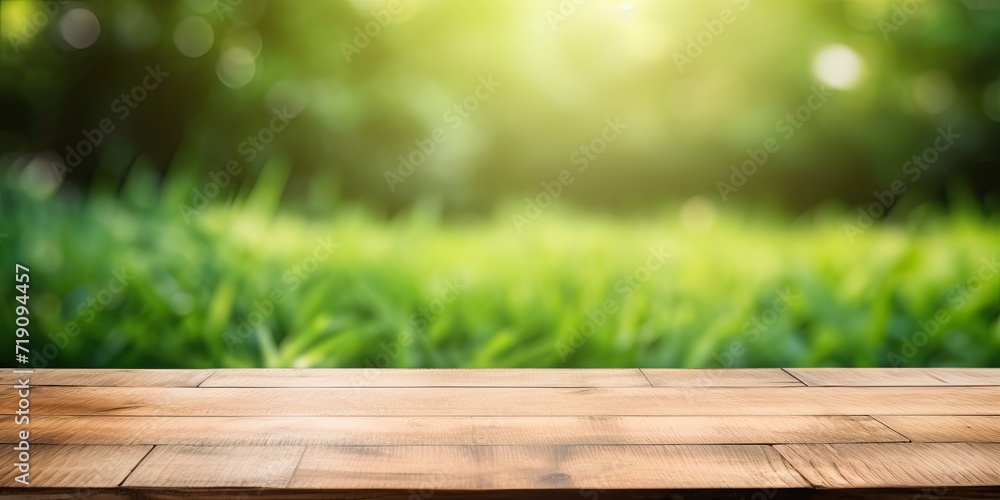Wooden table display with green grass background and blurred foliage. Wooden table display with green grass background and blurred foliage.