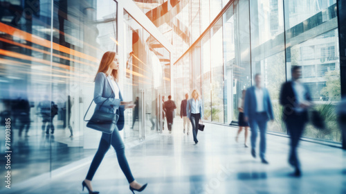 Motion blur of ambitious business people walking through lobby