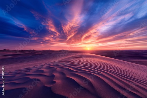 A breathtaking afterglow of a fiery sunset over a vast desert landscape, with the sky and clouds painted in vibrant hues, creating a stunning horizon against the golden sand dunes below
