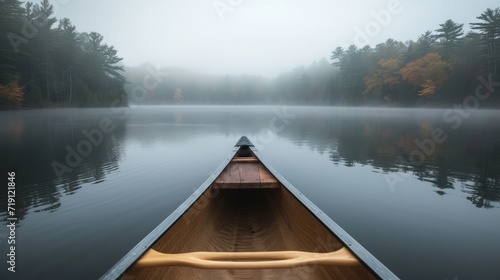 Bow of a canoe in the morning on a misty lake in Ontario, Canada.    photo
