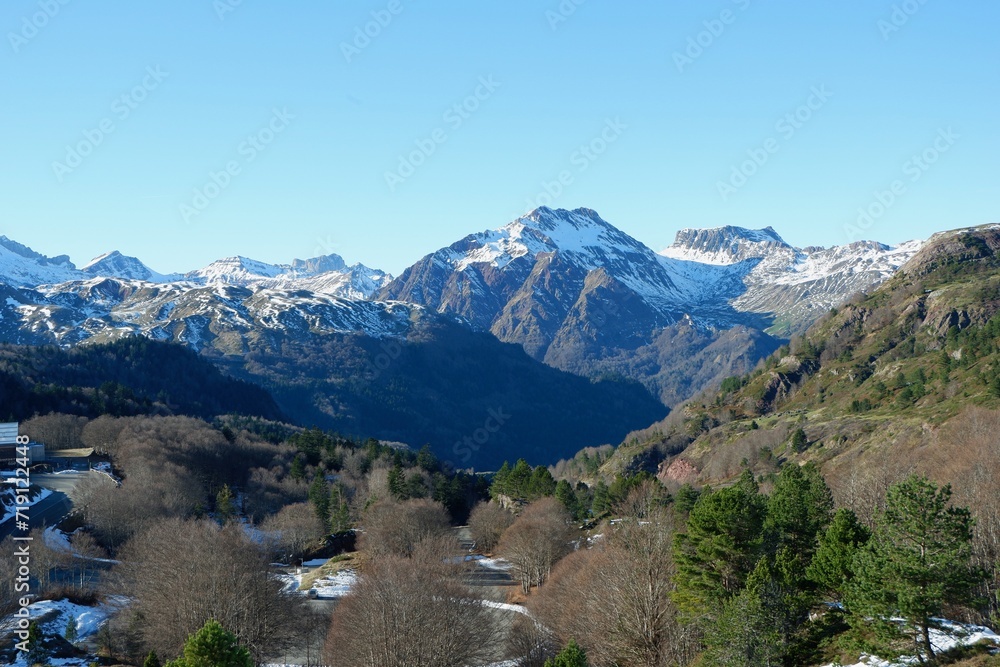 Calm mountain landscape with snow melting on the peaks at the border between Spain and France. Pyrenees national park