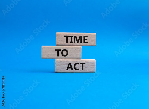 Time to Act symbol. Wooden blocks with words Time to Act. Beautiful blue background. Business and Time to Act concept. Copy space.