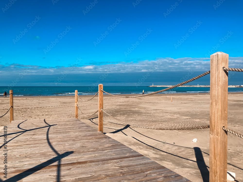 wooden walking path on beach with amazing view of sea and sky