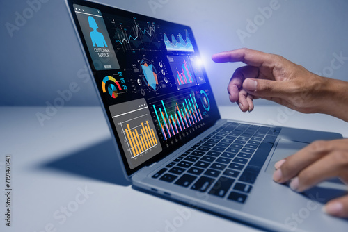 Business hands using digital laptop with business infographic data concept, Analytics data dashboard.