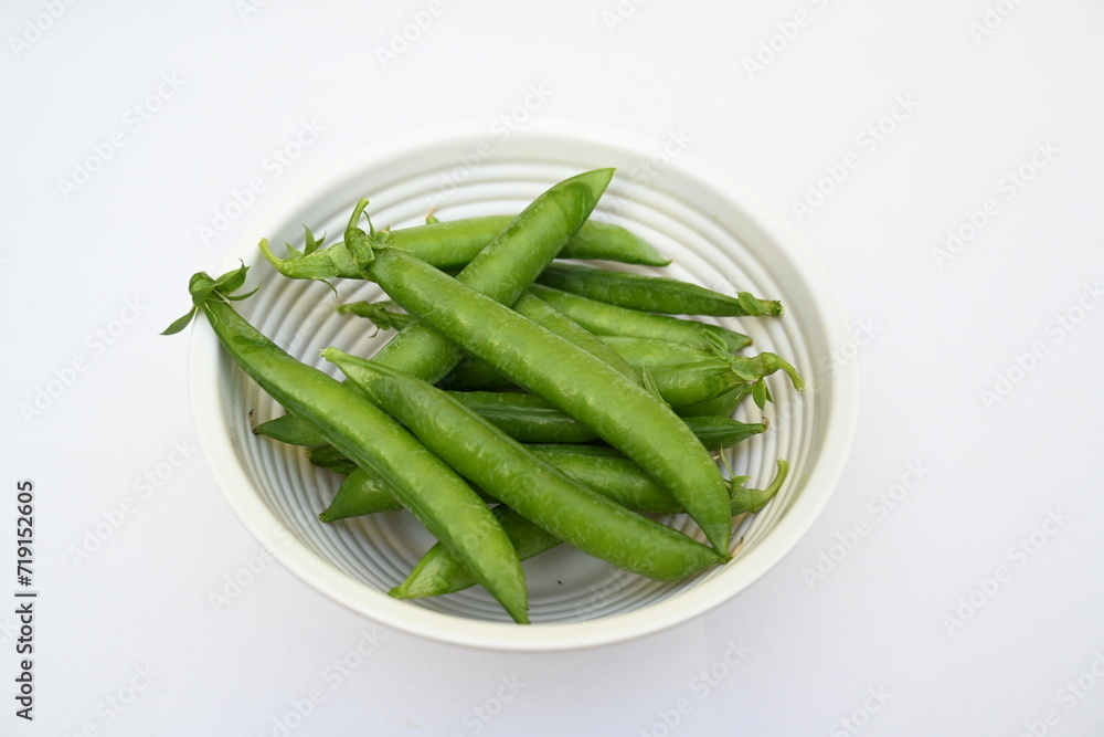 Fresh green pea isolated on white background. There is a lot of vitamins and Minerals in it. The pea is most commonly the small spherical seed or the seed. Popular vegetable of all over world. Fresh green pea isolated on white background. There is a lot of vitamins and Minerals in it. The pea is most commonly the small spherical seed or the seed. Popular vegetable of all over world.