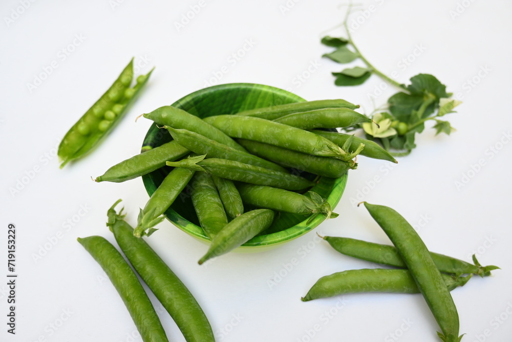 Fresh green pea isolated on white background. There is a lot of vitamins and Minerals in it. The pea is most commonly the small spherical seed or the seed. Popular vegetable of all over world. Fresh green pea isolated on white background. There is a lot of vitamins and Minerals in it. The pea is most commonly the small spherical seed or the seed. Popular vegetable of all over world.