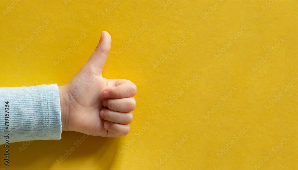 Child hand shows thumb up on yellow background. Paper cut style.2 - Copy.jpg