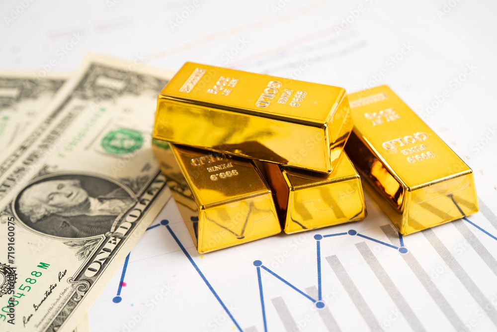 Gold bar on graph with US dollar banknote, economy finance exchange trade investment. Gold bar on graph with US dollar banknote, economy finance exchange trade investment.