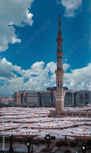 Top birds eye view of minaret of masjid Al Nabawi mosque minaret and canopy umbrella shades in Madinah, Saudi Arabia.