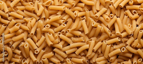 Vibrant top view of italian pennettine pasta as abstract background with textured patterns