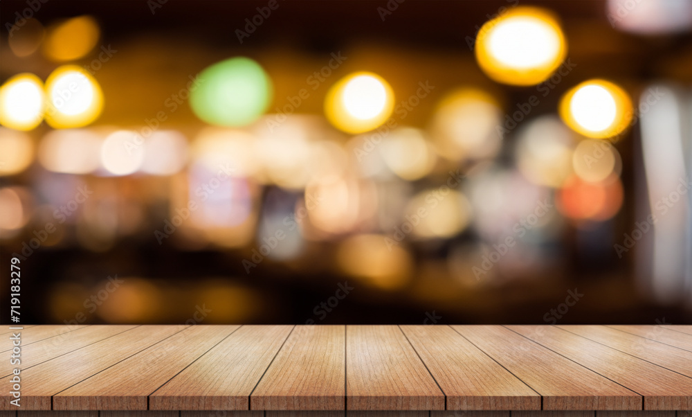 Empty wooden table top with lights bokeh on blur restaurant background.