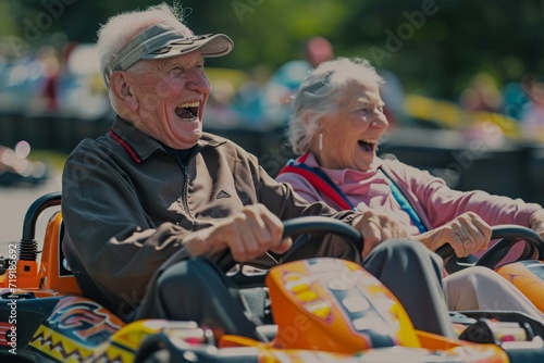 A couple of cheerful elderly people go karting © Александр Лобач