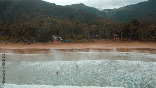 Aerial view of Nagtabon Beach in Palawan Philippines following heavy rains. stormy clouds and waves lapping onto the beach. photo