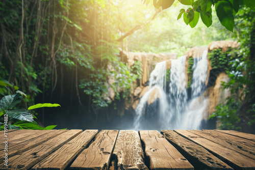 Wood table top podium floor in outdoor waterfall green tropical forest nature background.