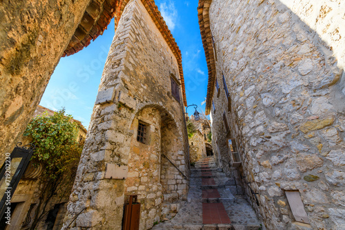 Fototapeta Naklejka Na Ścianę i Meble -  The narrow hillside alleys and streets of shops and cafes inside the medieval hilltop village of Eze, France, along the Cote d'Azur French Riviera.