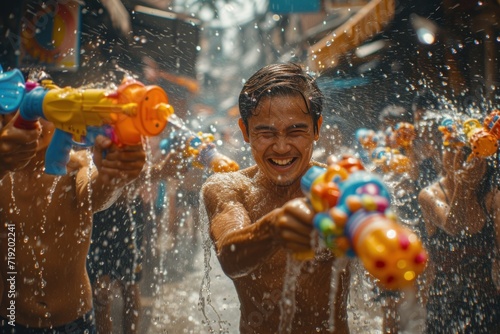 A tourists and foreign friends play in the water in Thailand on Songkran Celebrate Songkran Festival holding a colorful water gun