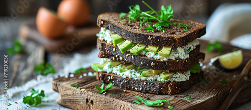 Sandwich with black rye bread, cottage cheese and avocado mousse