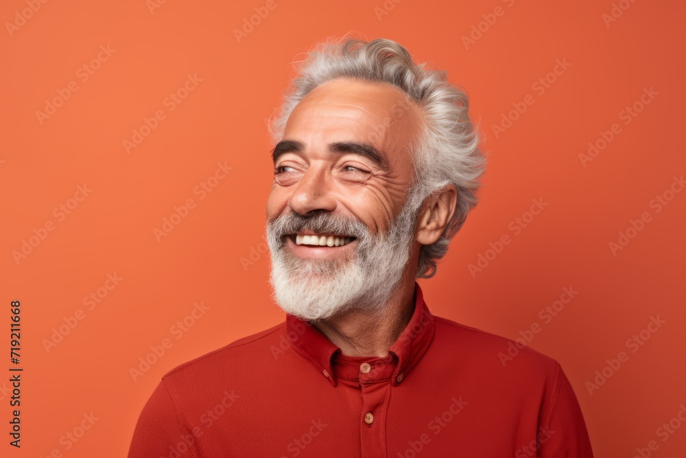 Portrait of happy senior man in red shirt. Isolated over orange background Portrait of happy senior man in red shirt. Isolated over orange background