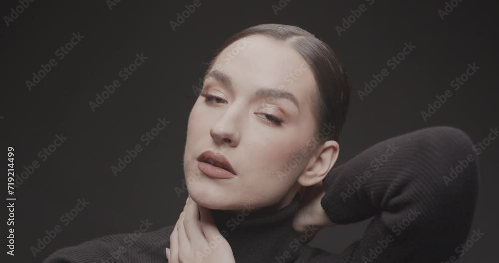 Portrait shooting of a young woman in a studio on a black background Portrait shooting of a young woman in a studio on a black background