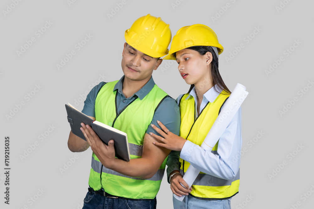 Asian Couple Engineer & Architect gives gestures and expressions on construction field with charts Asian Couple Engineer & Architect gives gestures and expressions on construction field with charts
