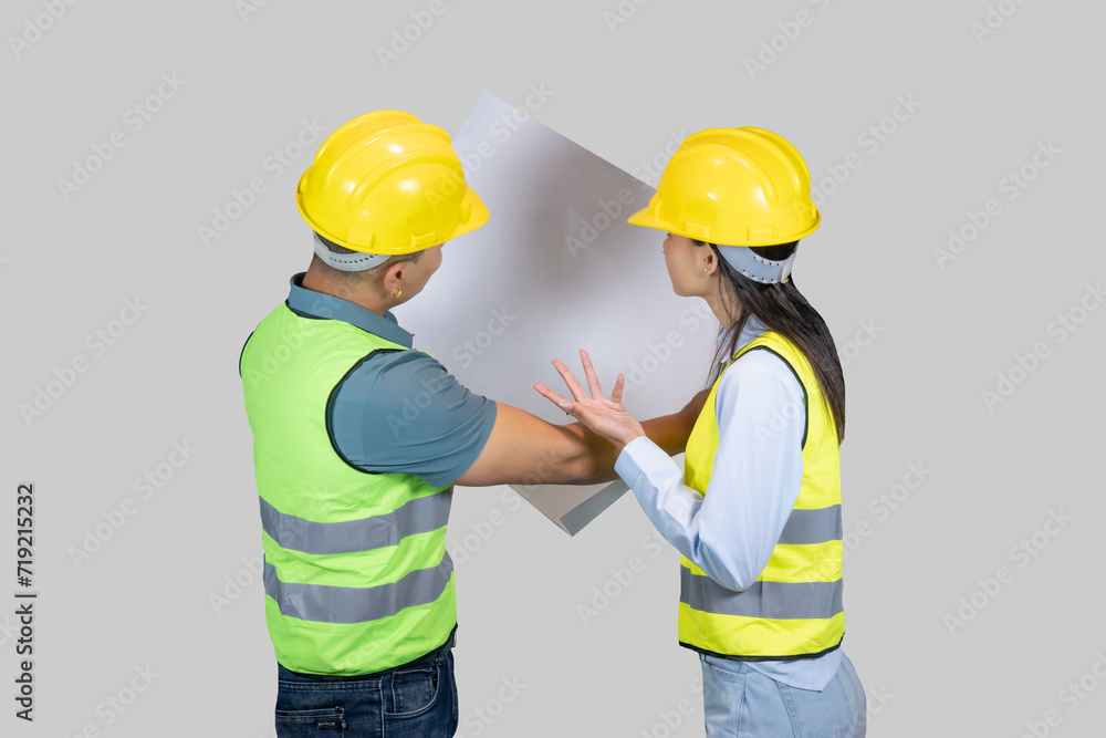Asian Couple Engineer & Architect gives gestures and expressions on construction field with charts Asian Couple Engineer & Architect gives gestures and expressions on construction field with charts