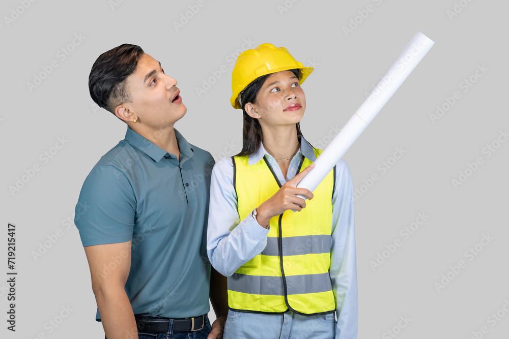 Asian Couple Engineer & Architect gives gestures and expressions on construction field with charts Asian Couple Engineer & Architect gives gestures and expressions on construction field with charts