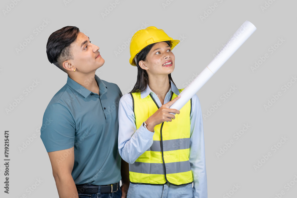 Asian Couple Engineer & Architect gives gestures and expressions on construction field with charts Asian Couple Engineer & Architect gives gestures and expressions on construction field with charts
