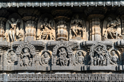 Beautiful intricate patterns and carvings of figurines on the wall of the ancient Chennakeshava temple in Belur, Karnataka. photo