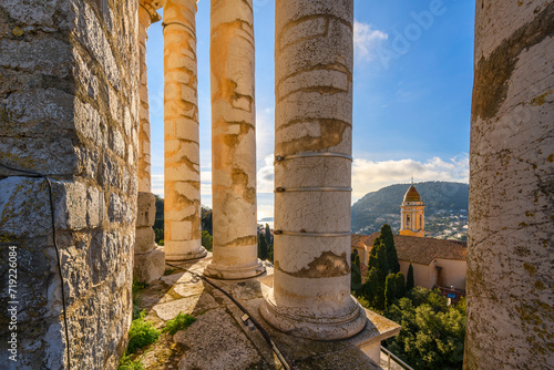 View from inside the columns at the top of the ancient Roman Trophy of Augustus monument of the Mediterranean Sea and church of La Turbie, in the historic town of La Turbie, France. photo