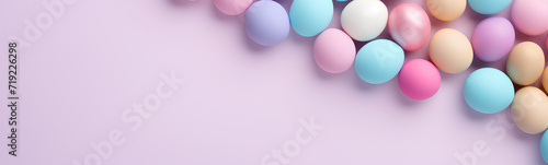 Flat lay of colored Easter eggs. Plain pastel background. photo