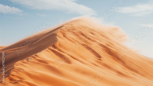 Strong winds blow the sand off the top of the dune