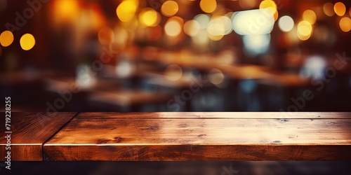 Cafe restaurant background with dark night blur, empty wooden tabletop.