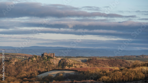Carreg Cennan Castle, near Llandeilo, south Wales on a frosty winter's morning. The castle is located on a hilltop, overlooking the rural landscape photo