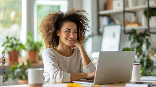 Woman Sitting in Front of Laptop Computer. Generative AI.